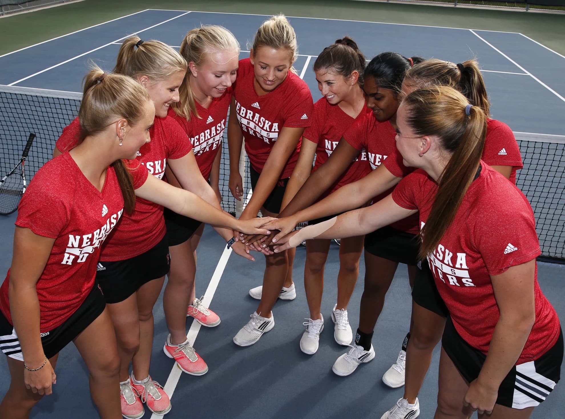 A team stands in a circle preparing for the game.