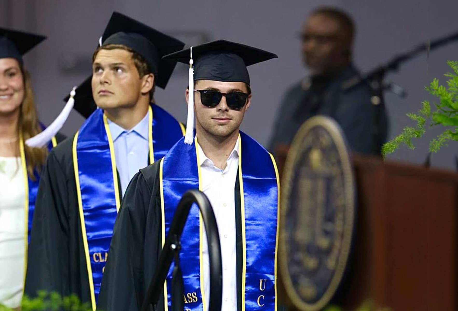 Two students on a podium after completing their semester.
