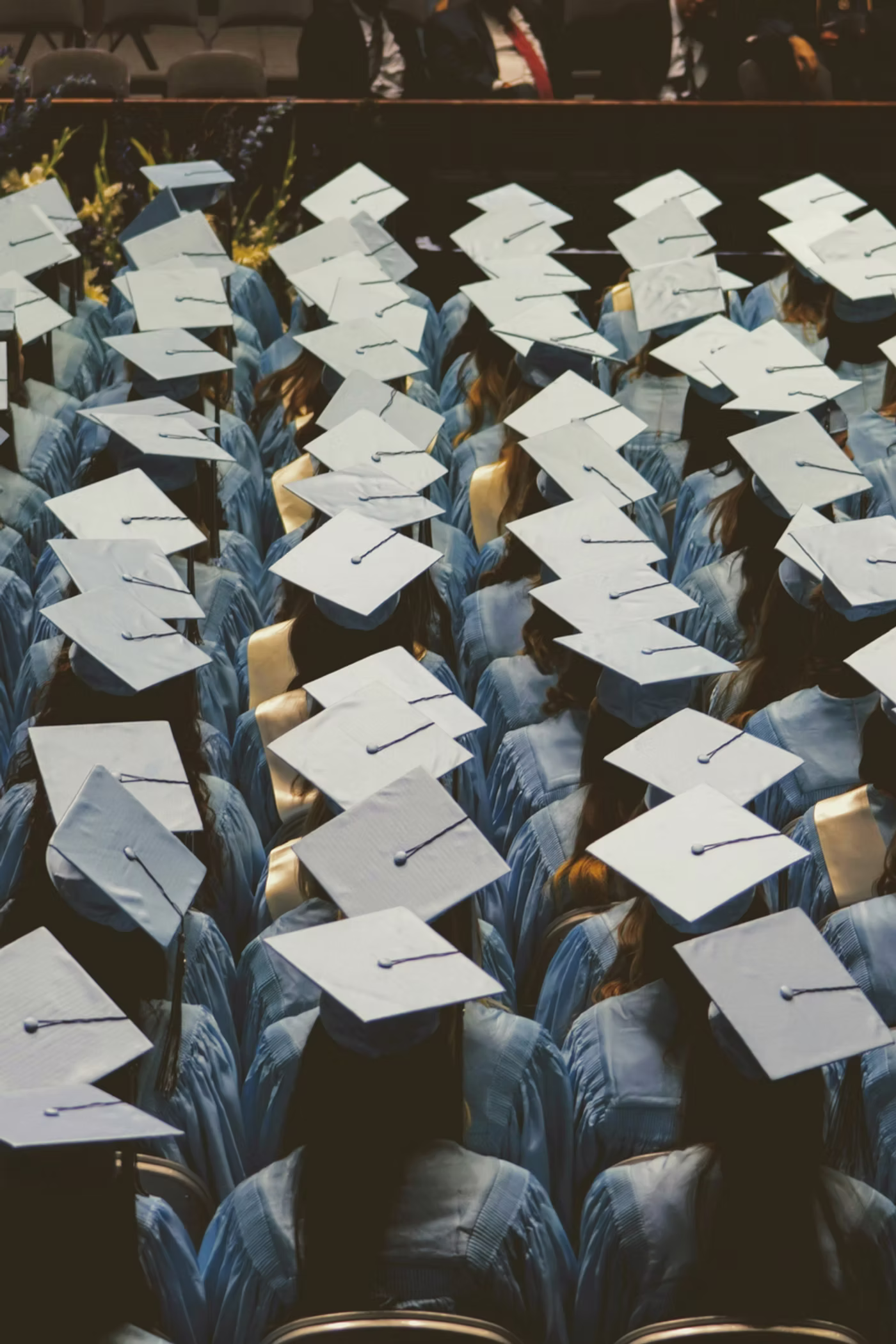 Graduates in caps and gowns seen from above.
