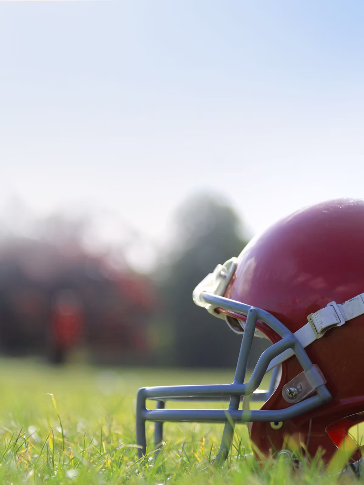 American football helmet on grass – backdrop for financial packages.