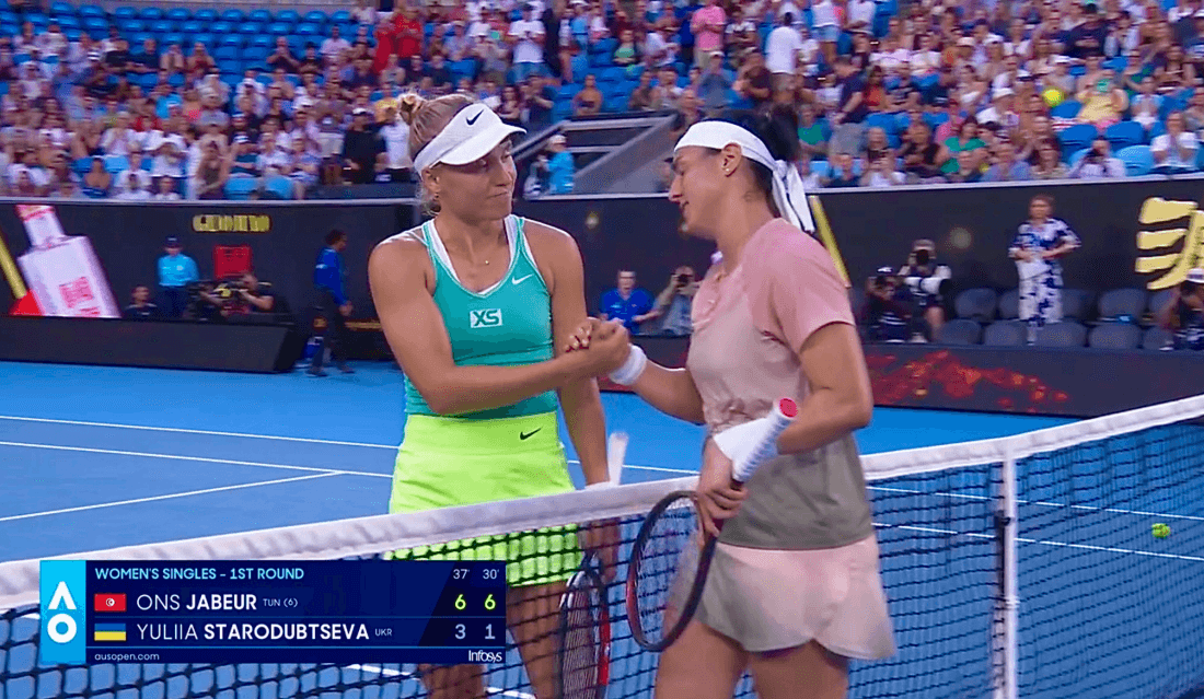 Yuliia Starodubtseva shaking hands with Ons Jabeur at the net after their Australian Open first-round match.
