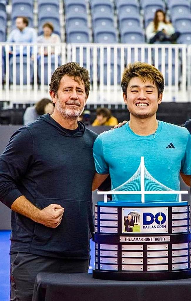 David Pierce with an athlete on a tennis court